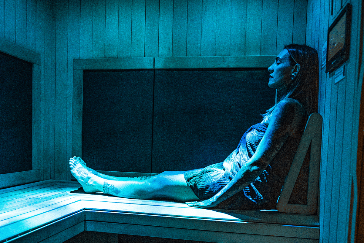 Woman sitting in the infrared sauna at Sloco in San Luis Obispo.